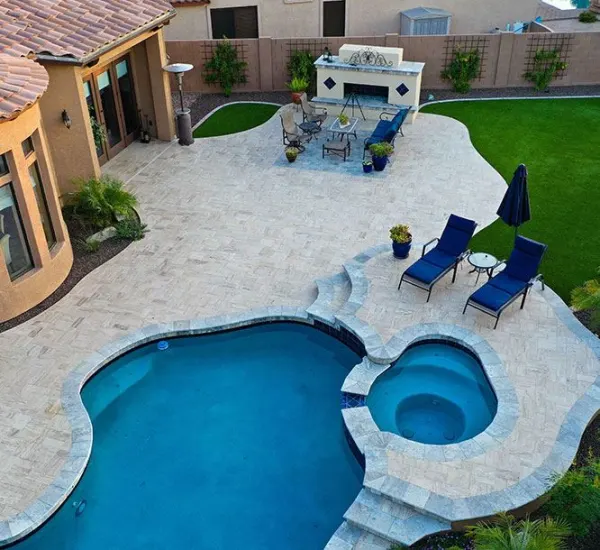 Beautiful remodeled pool deck with family enjoying