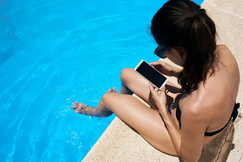 Woman by pool with phone