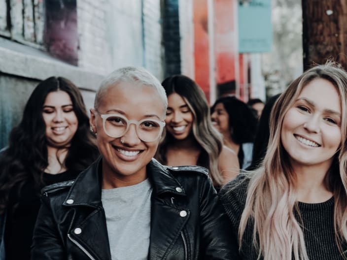 group of friends walking down a city street