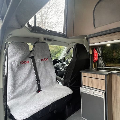 The inside of Selene with the bench seat rotated and the pop-top up
