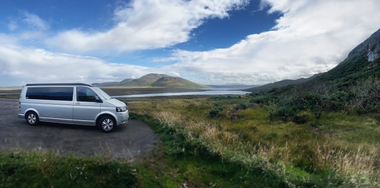 Selene the Camper parking in front a stunning vista in Scotland