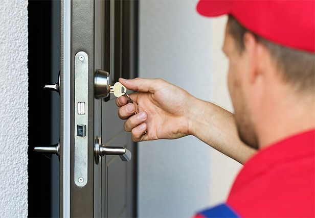 Locksmith turning a key in a lock