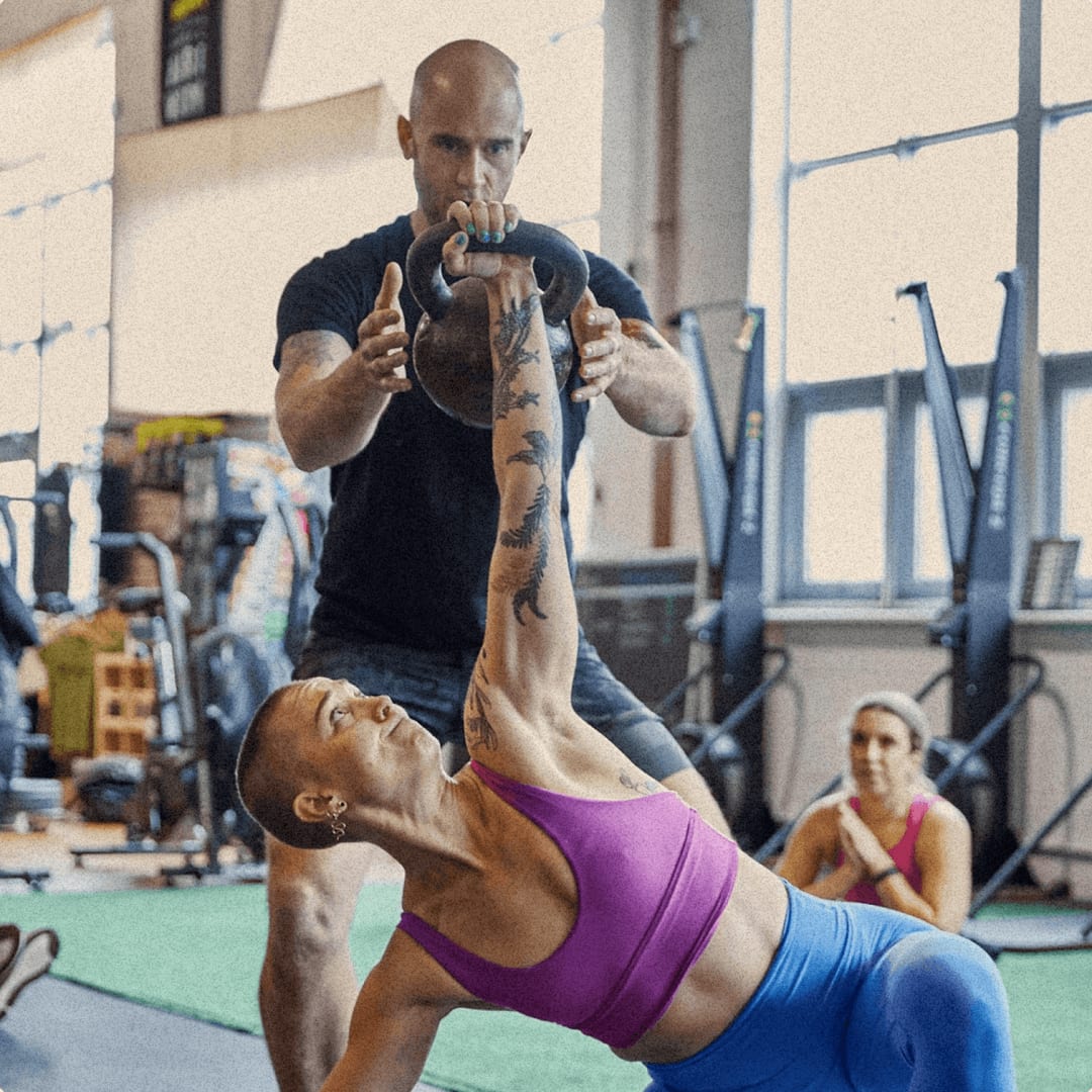Coach with a personal training client in a gym using Somble