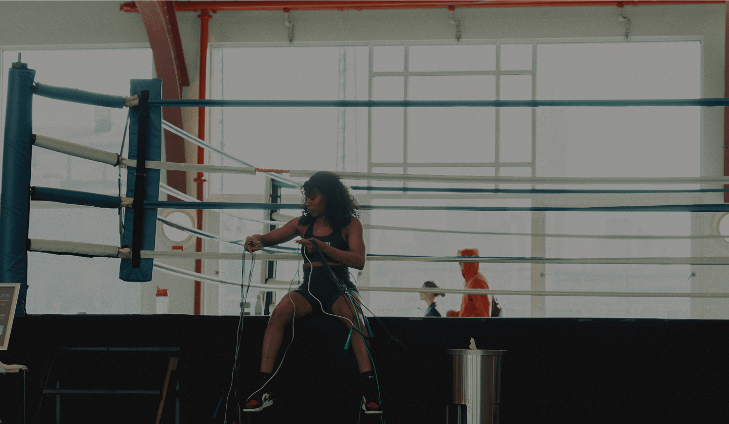Hero image of a fitness coach training his client with kettlebells in a gym