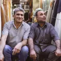 Two persian guys sitting in a Bazaar