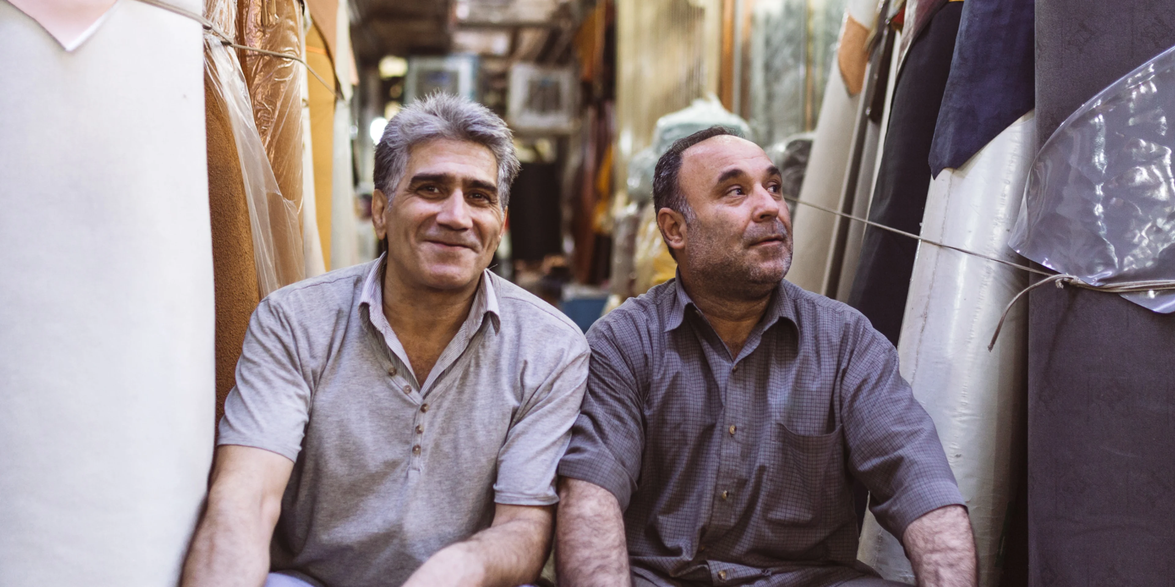 Candid photo of two Persian people at a Tehran Bazaar