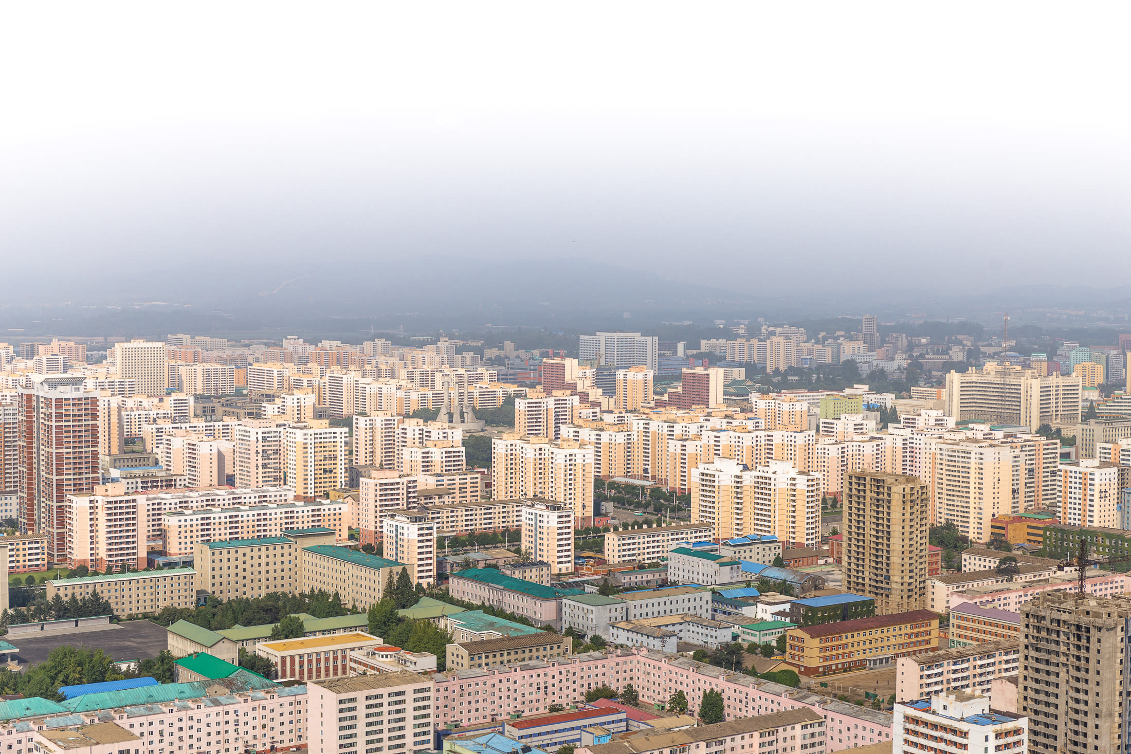 A bleak view of a pink concrete jungle of apartment blocks.
