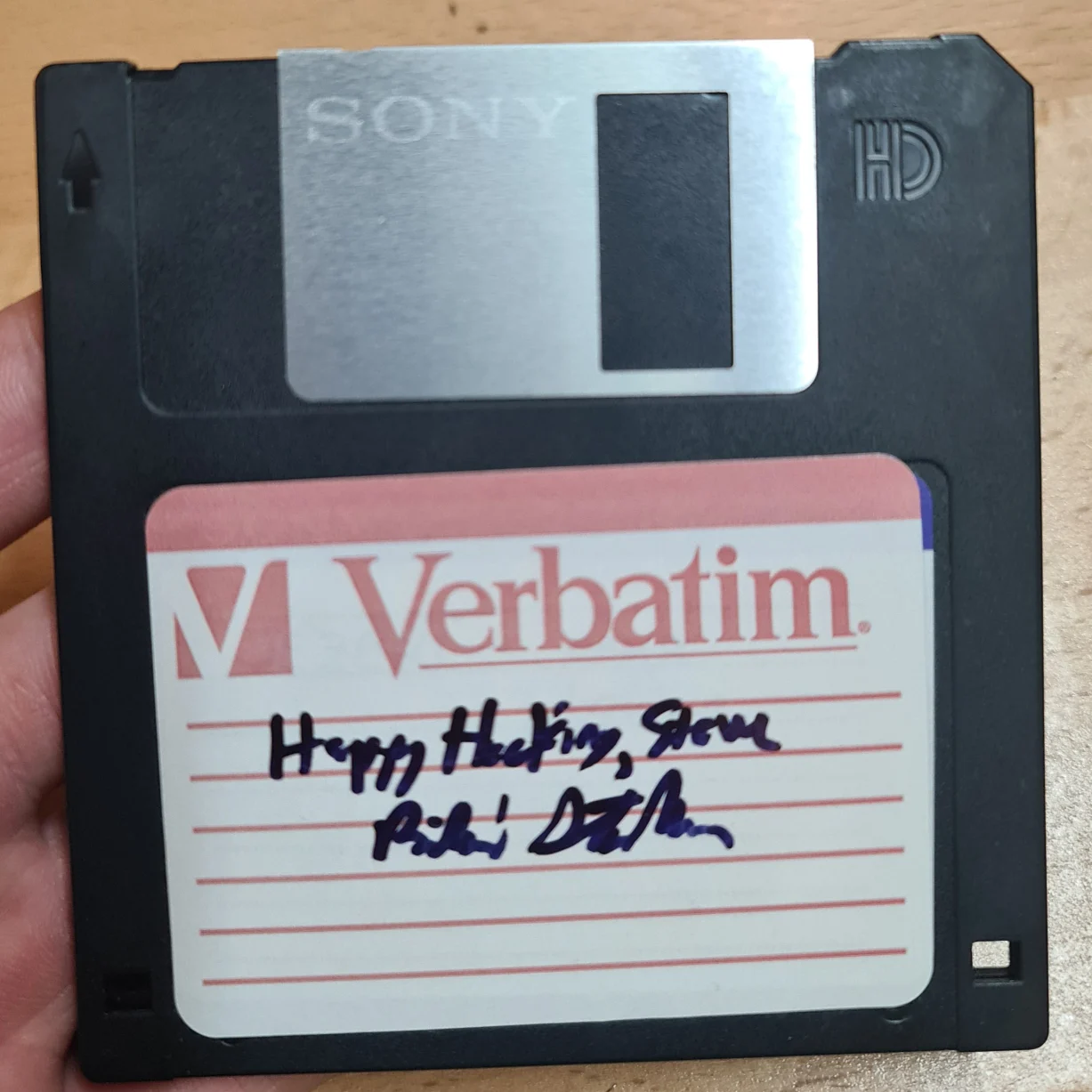 Photo of a floppy disk signed "Happy Hacking, Steve. Richard Stallman"