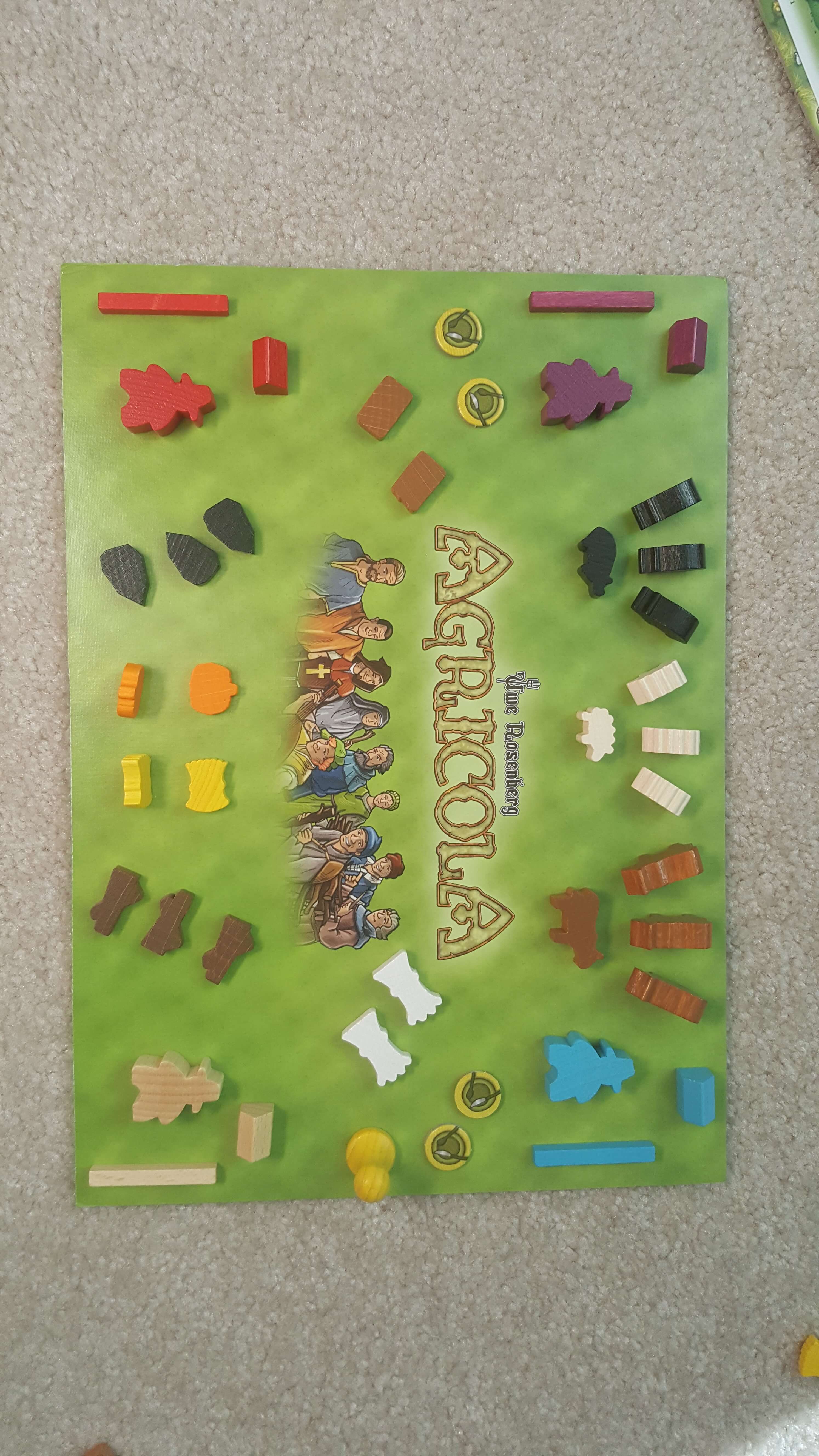 The shaped wooden animals and resource pieces in Agricola