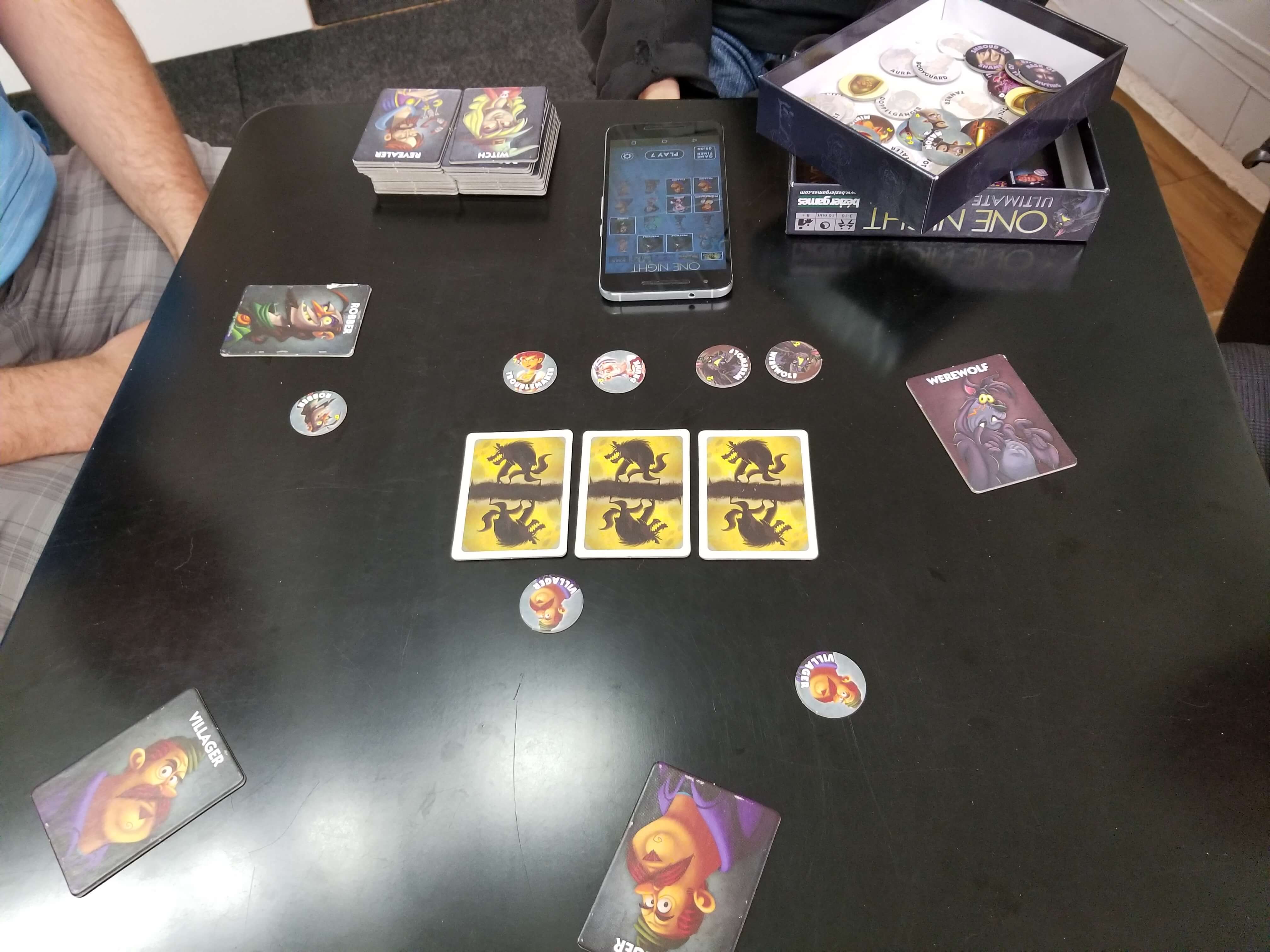The table layout with role cards dealt face-up before play