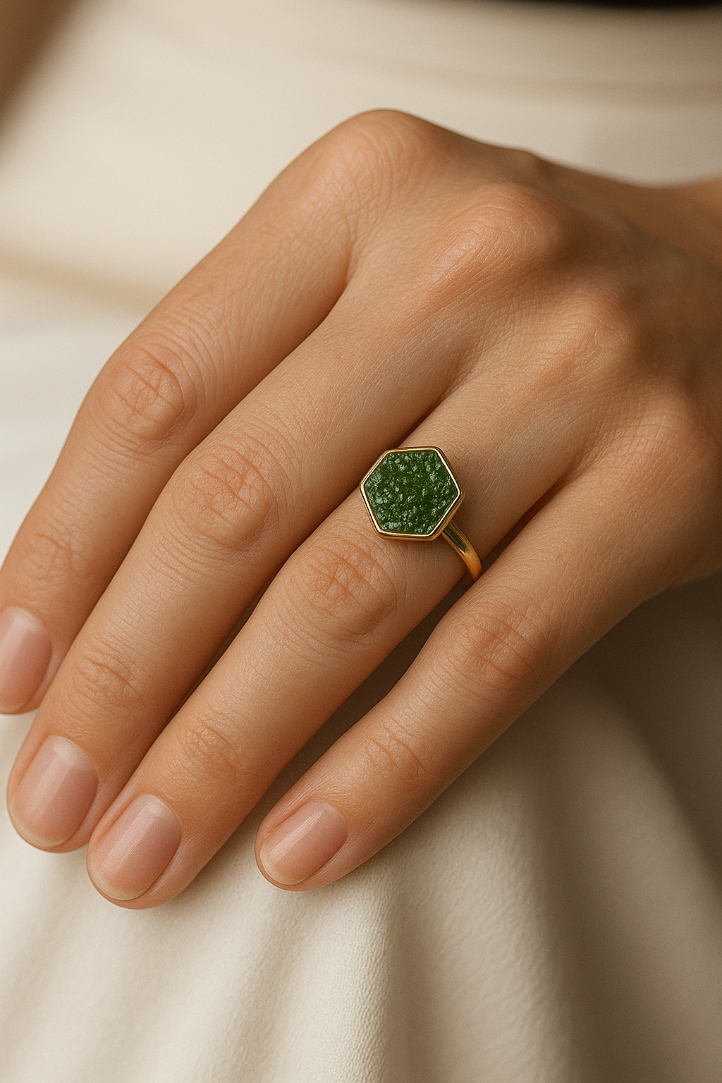 Hexagonal green gemstone gold ring on hand model