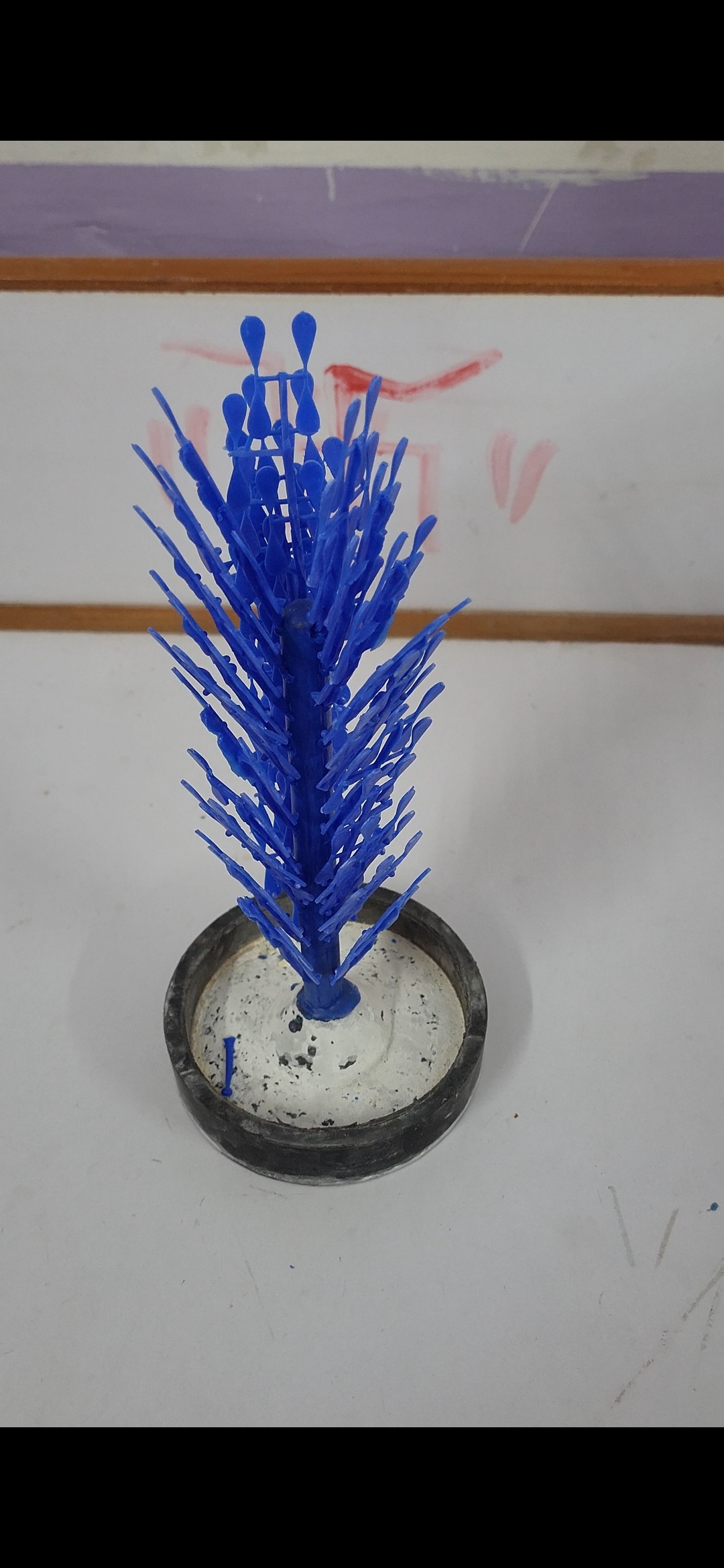 3D printer printing highly detailed blue wax jewelry models