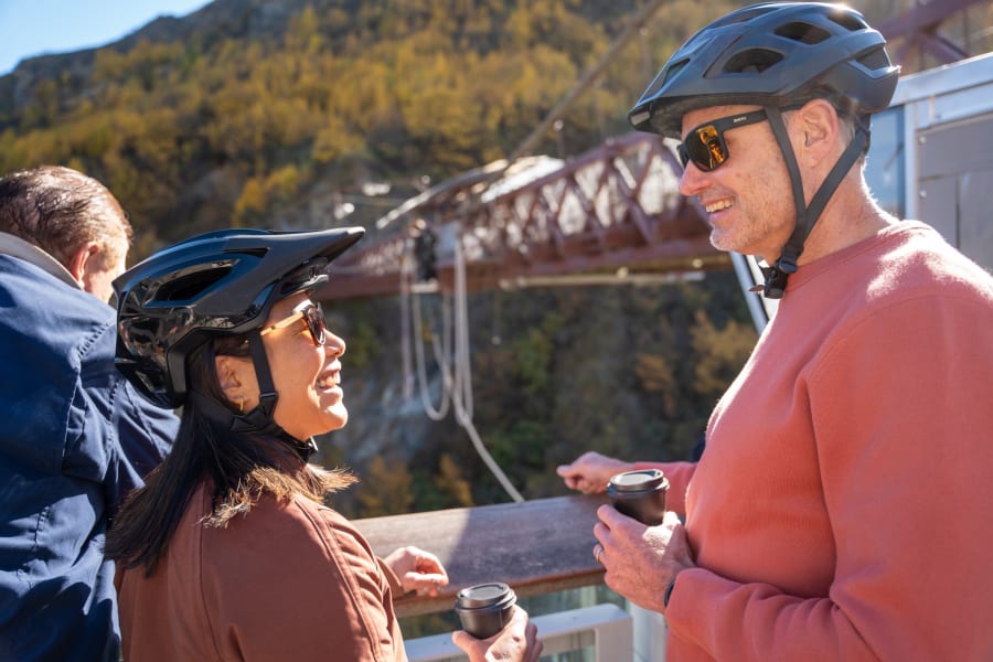 E-bike riders pausing for a takeaway coffee with the Kawarau bungy bridge in the background