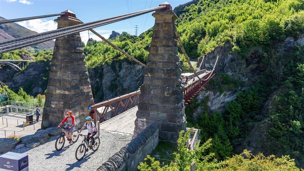 Cyclists crossing the Kawarau Suspension Bridge