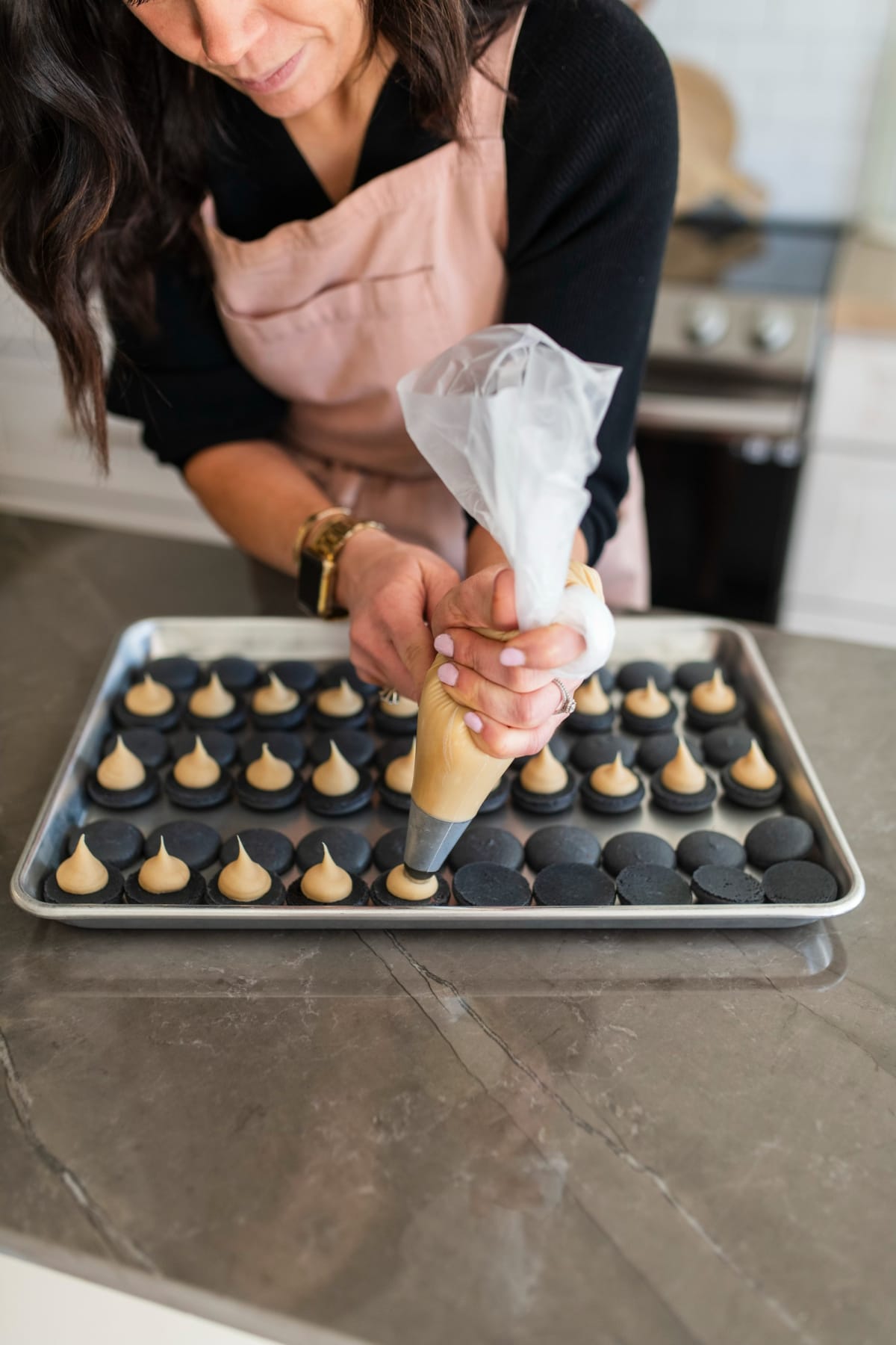 Piping filling onto macaron shells