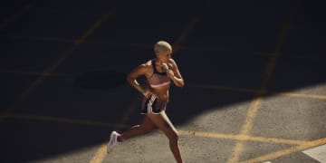 Woman in adidas equipment running on the street