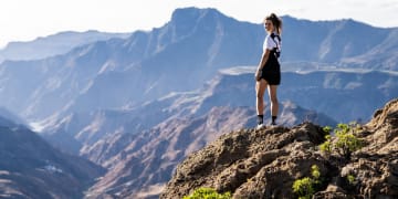 Trail runner standing on top of a mountain