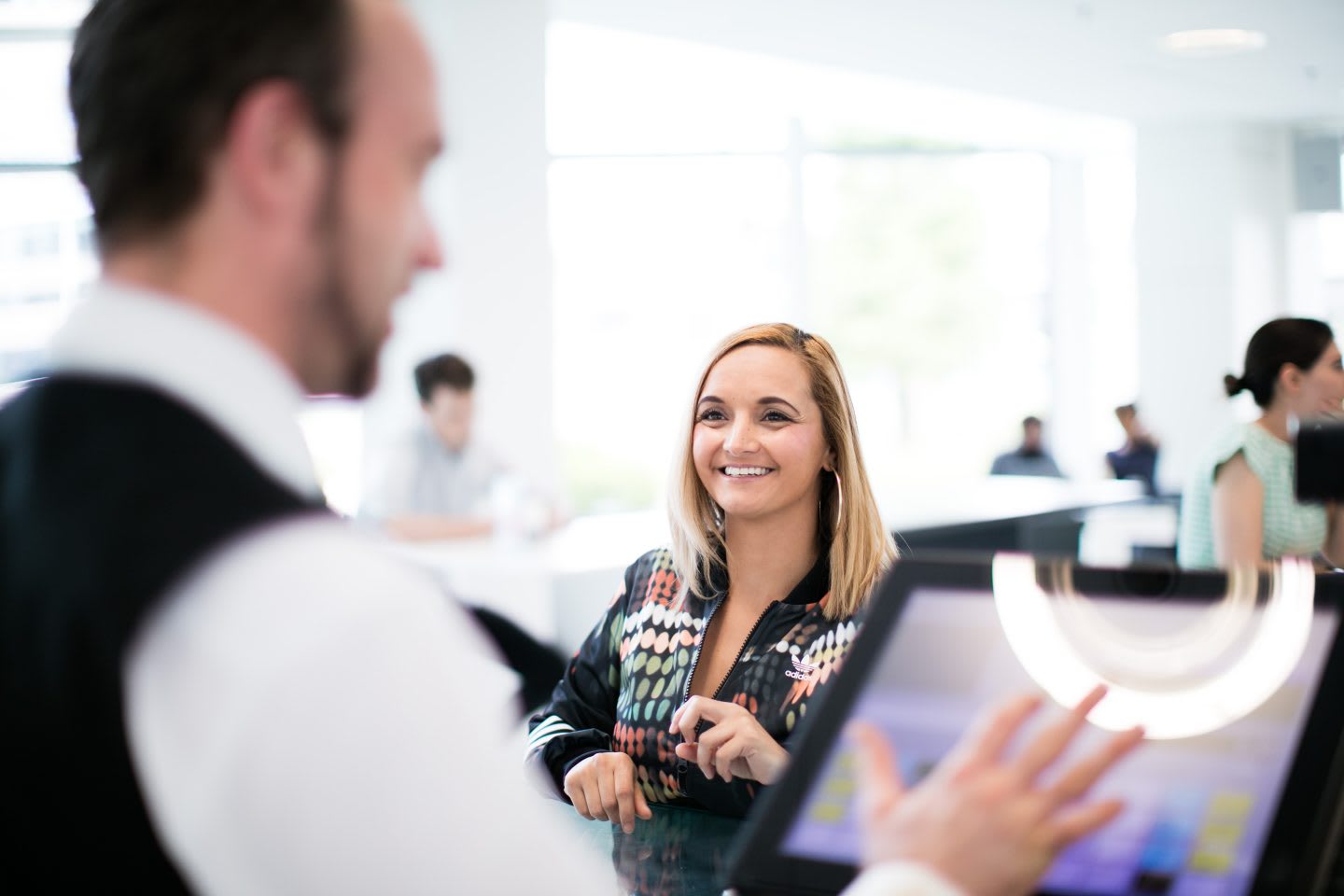 Woman standing in a coffee bar at adidas. GamePlan A - attitude at work - positivity - job - atmosphere