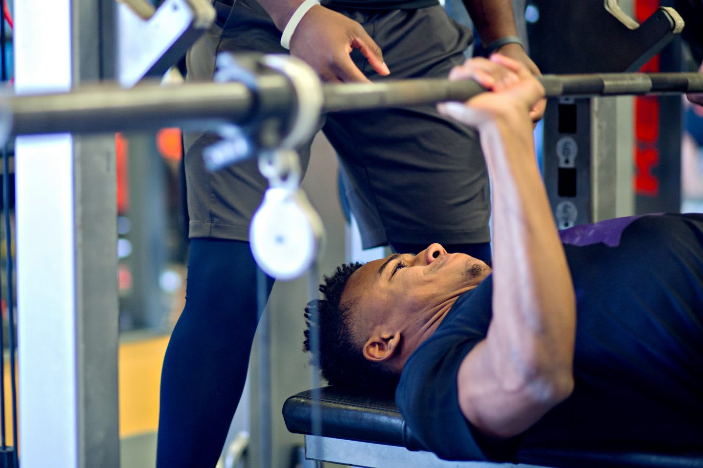 a man is weight lifting and looks concentrated and exhauseted_exos_training_weigt lifiting_persue goals
