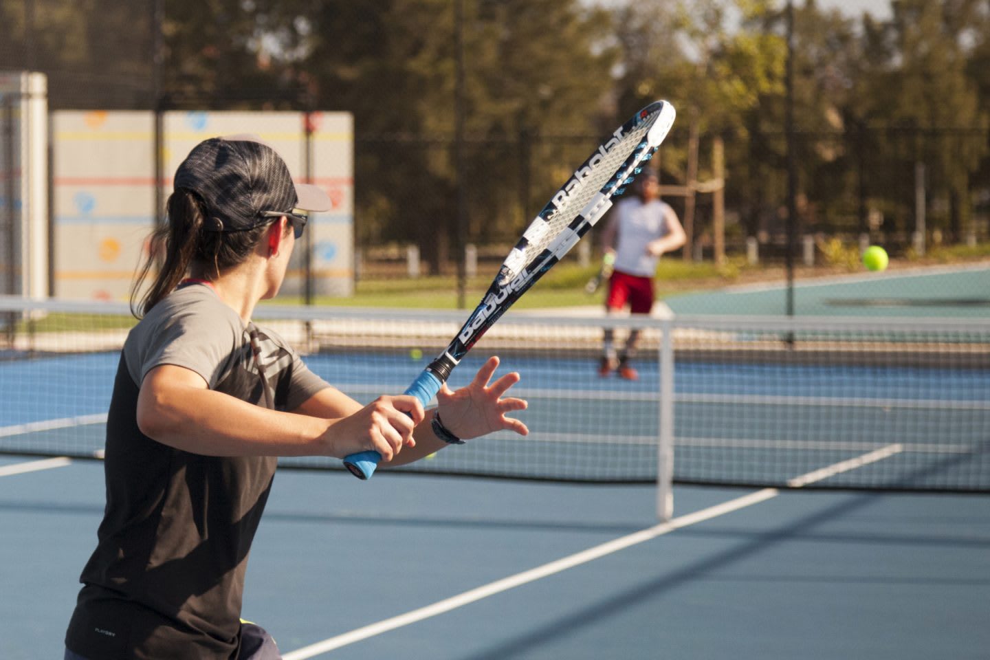 Two people playing tennis on a sunny day.Tennis, sports, fitness, motivation, team.