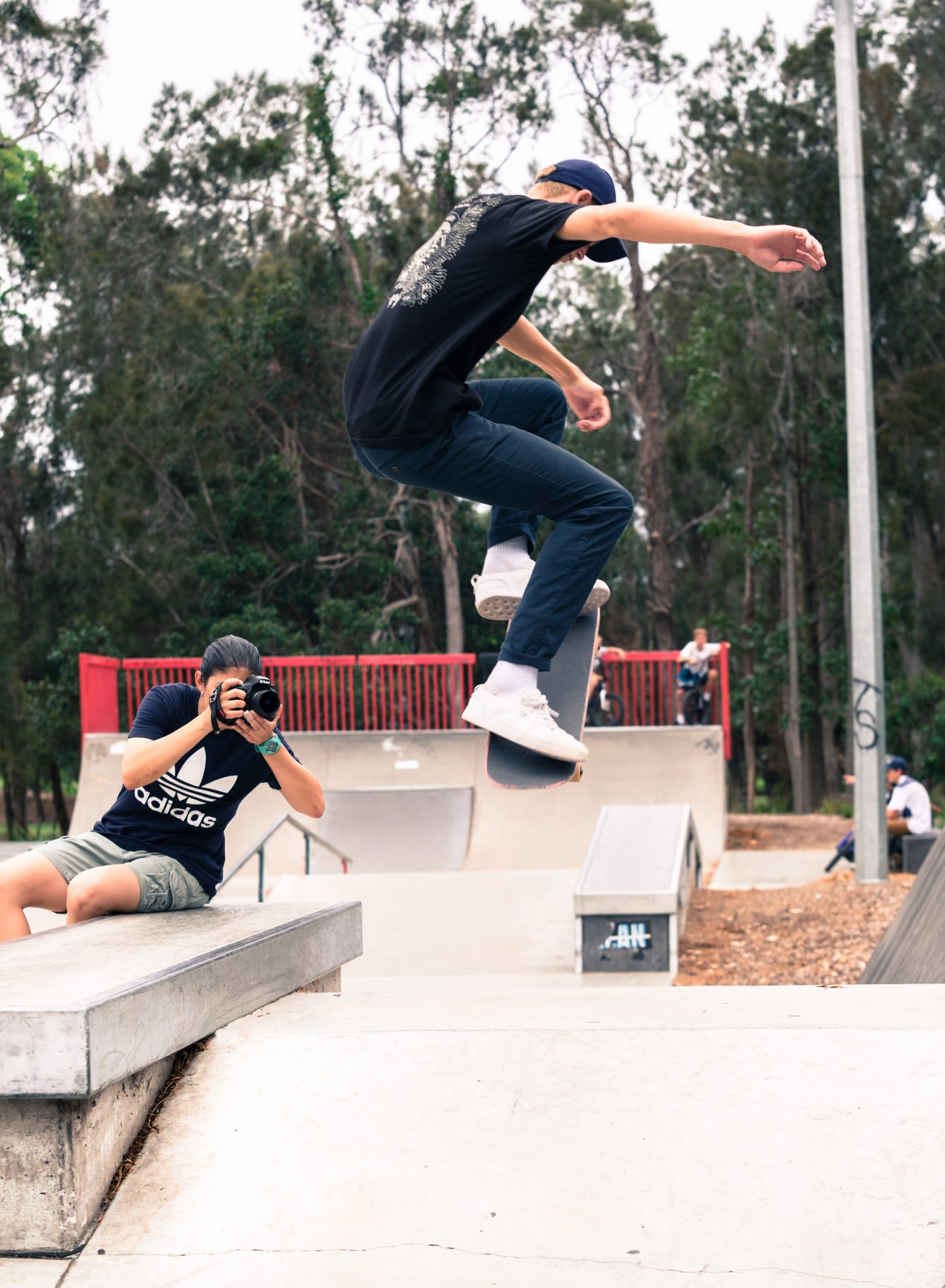 Joanne takes photos of a skater doing tricks in the skate park. Skater, skateboarding, photographer, passion, creator.