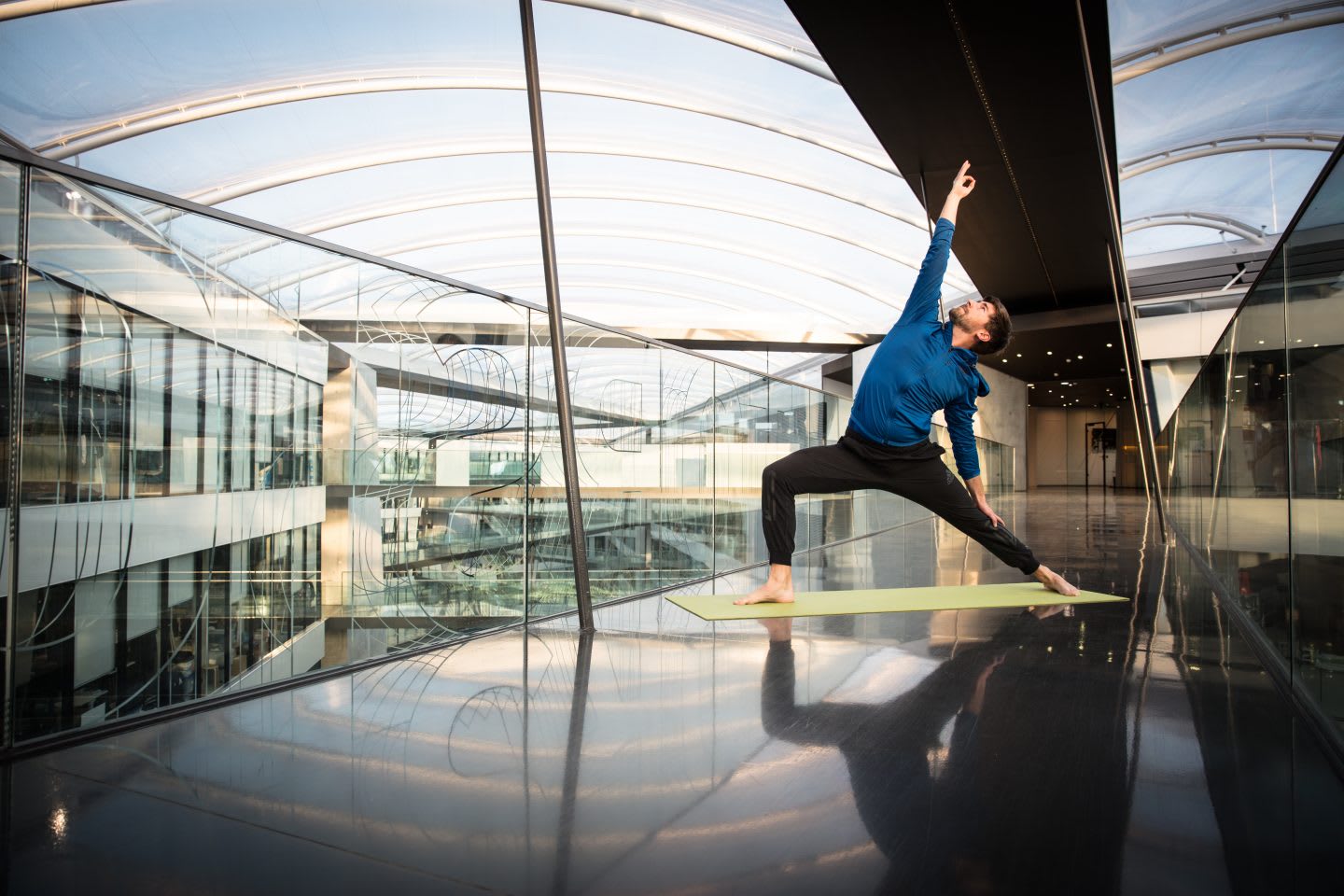 Man doing yoga in the center of his workplace. yoga, well being, sport, passion.