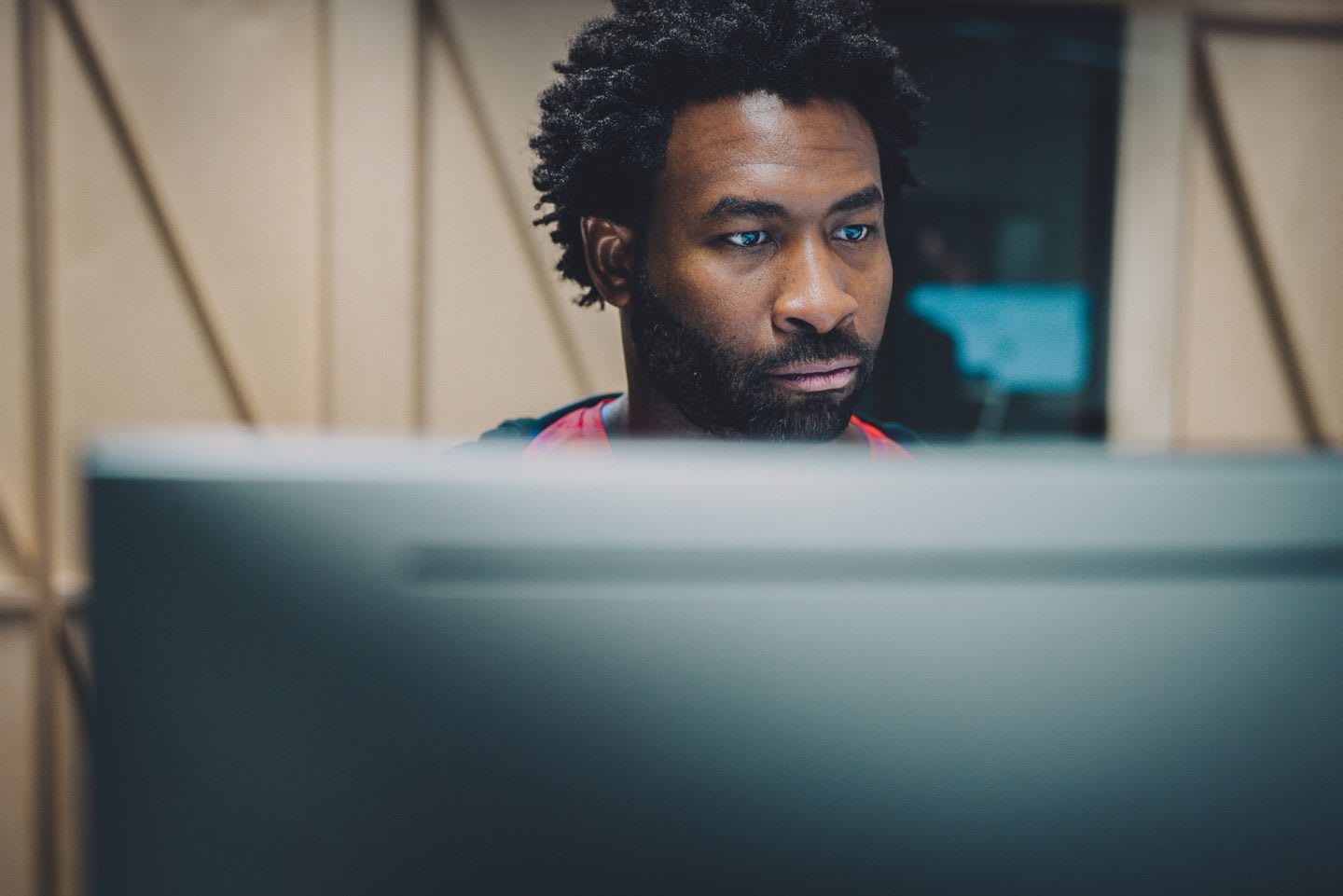 A man working behind a PC screen at adidas. HereToCreate, Digital, adidas employee, Basketball, teamwork, leadership, strategy