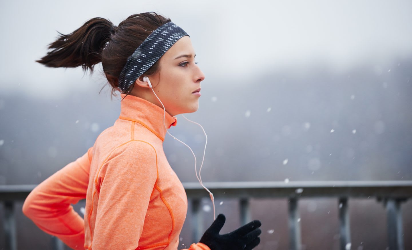 Cropped shot of a young woman running in the snow. running, outdoors, motivation, fitness, snowing.