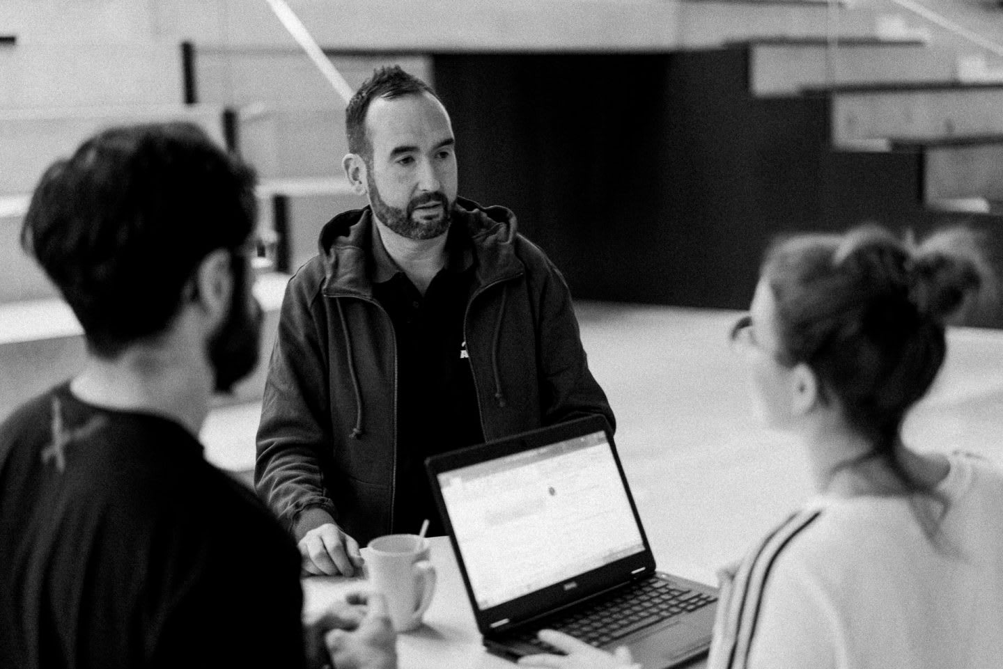 Three employees come together for a briefing. meeting, team, brief, colleagues.