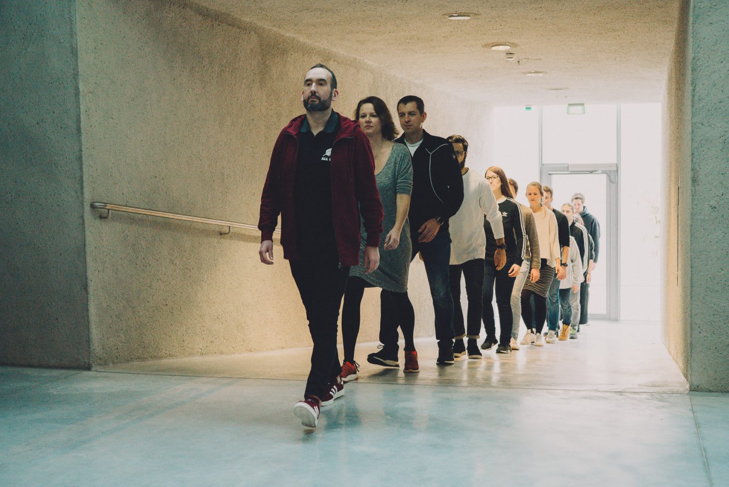 A group of colleagues walk together in a straight line. team, formation, line, discipline, togetherness.