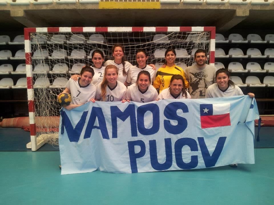 A group of children stand together holding a team flag after their team sport in front of a goal. teamwork, teammates sports, achievement, success
