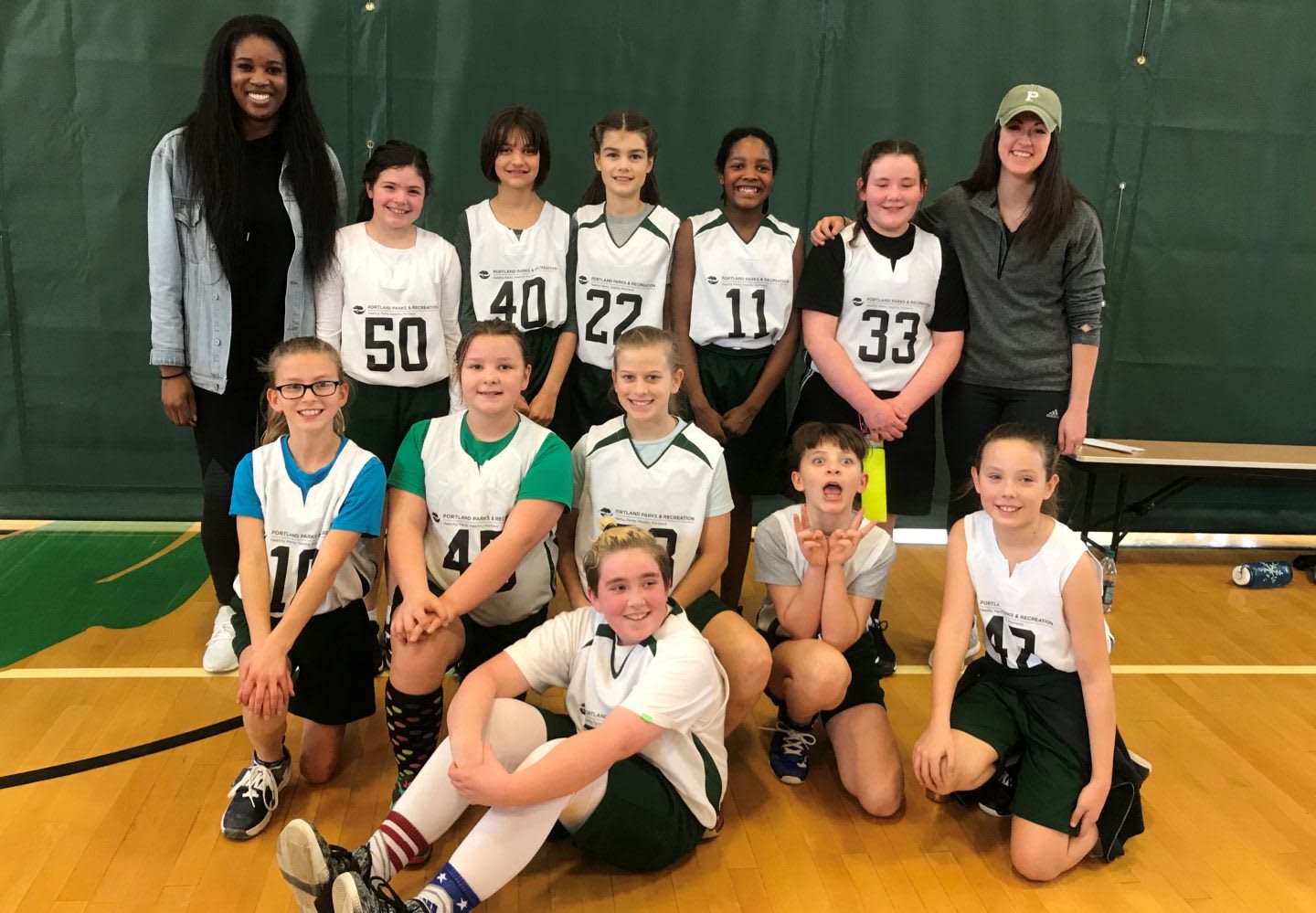 An all girls basketball team take a team photo together after a training session. team, basketball, sports, activity, teamwork