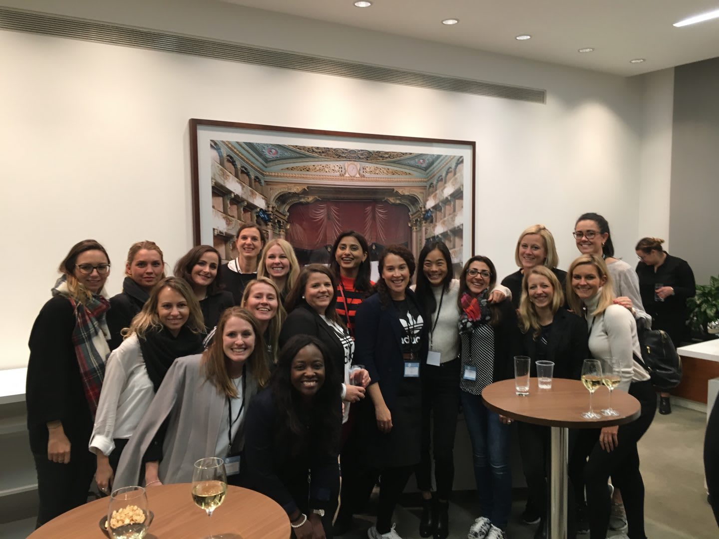 A group of women smiling during a conference in London.