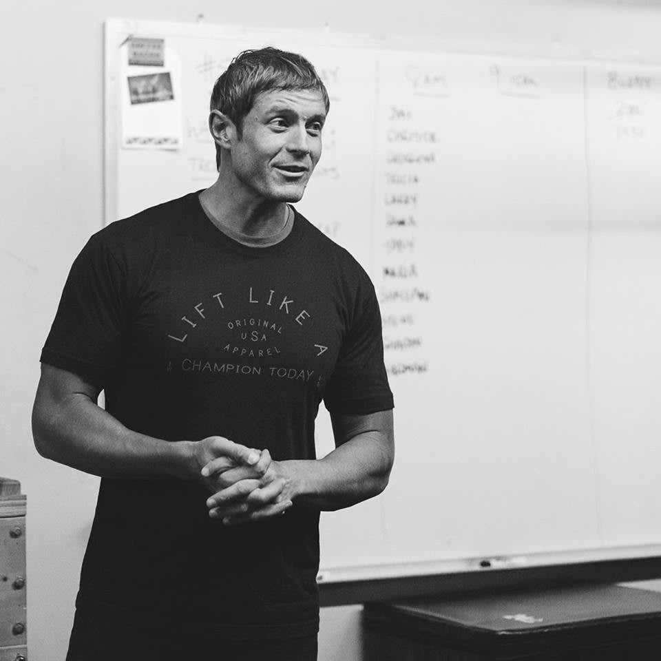 Black and white picture of fitness coach Dai Manuel presenting in front of a white board. injury, adidas, GamePlan A, setback, coach, coaching, motivation, career