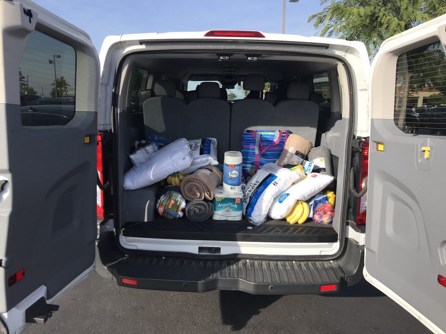 A white van is filled with running supplies. supplies, preparation,