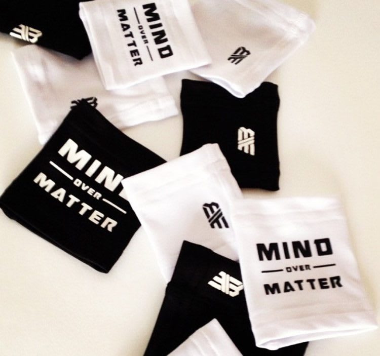 A black and white sports band says to put mind over matter.product, mind, thought, matter, band