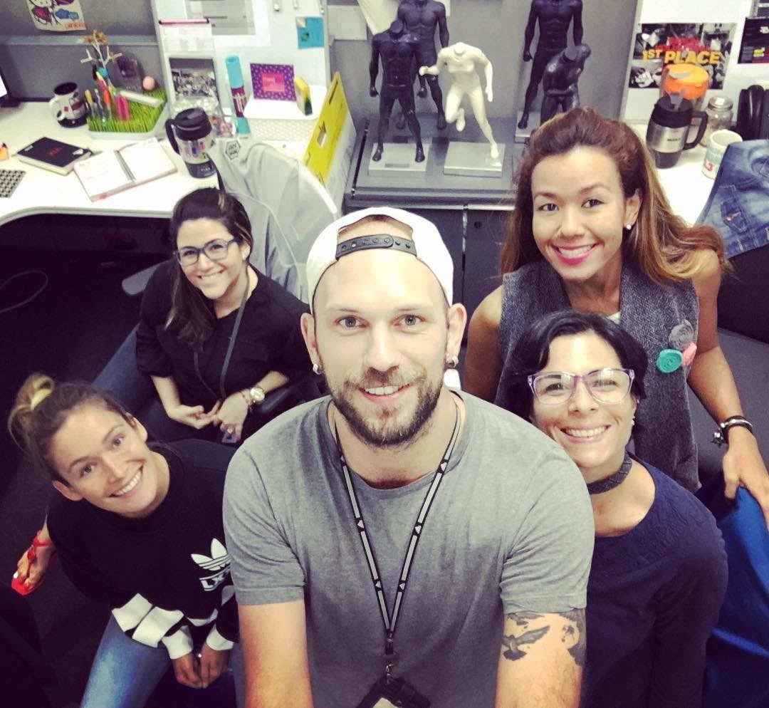 A group of work colleagues come together in their work environment. smile, happy, work, colleagues, team