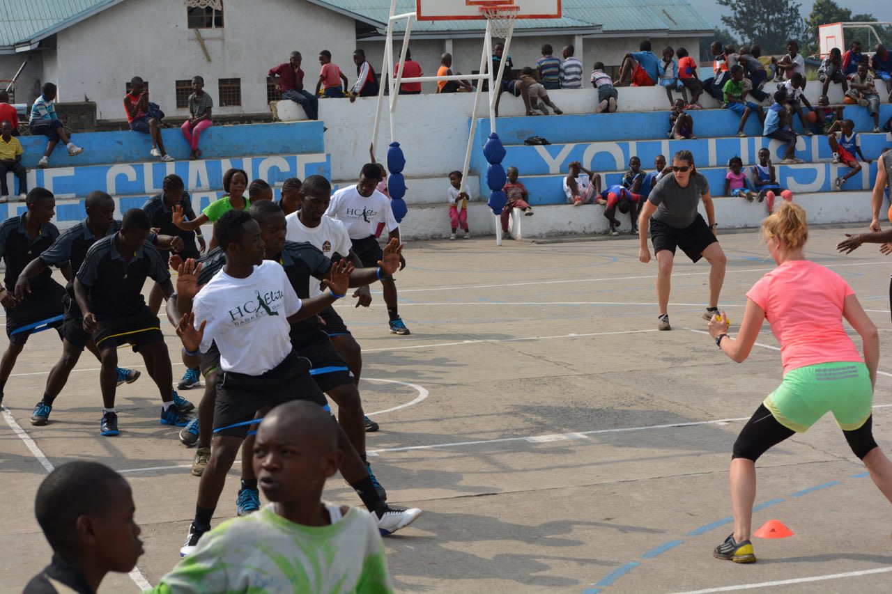 A group of African kids working out with two volunteers from adidas. volunteering, adidas, leadership, leadership skills