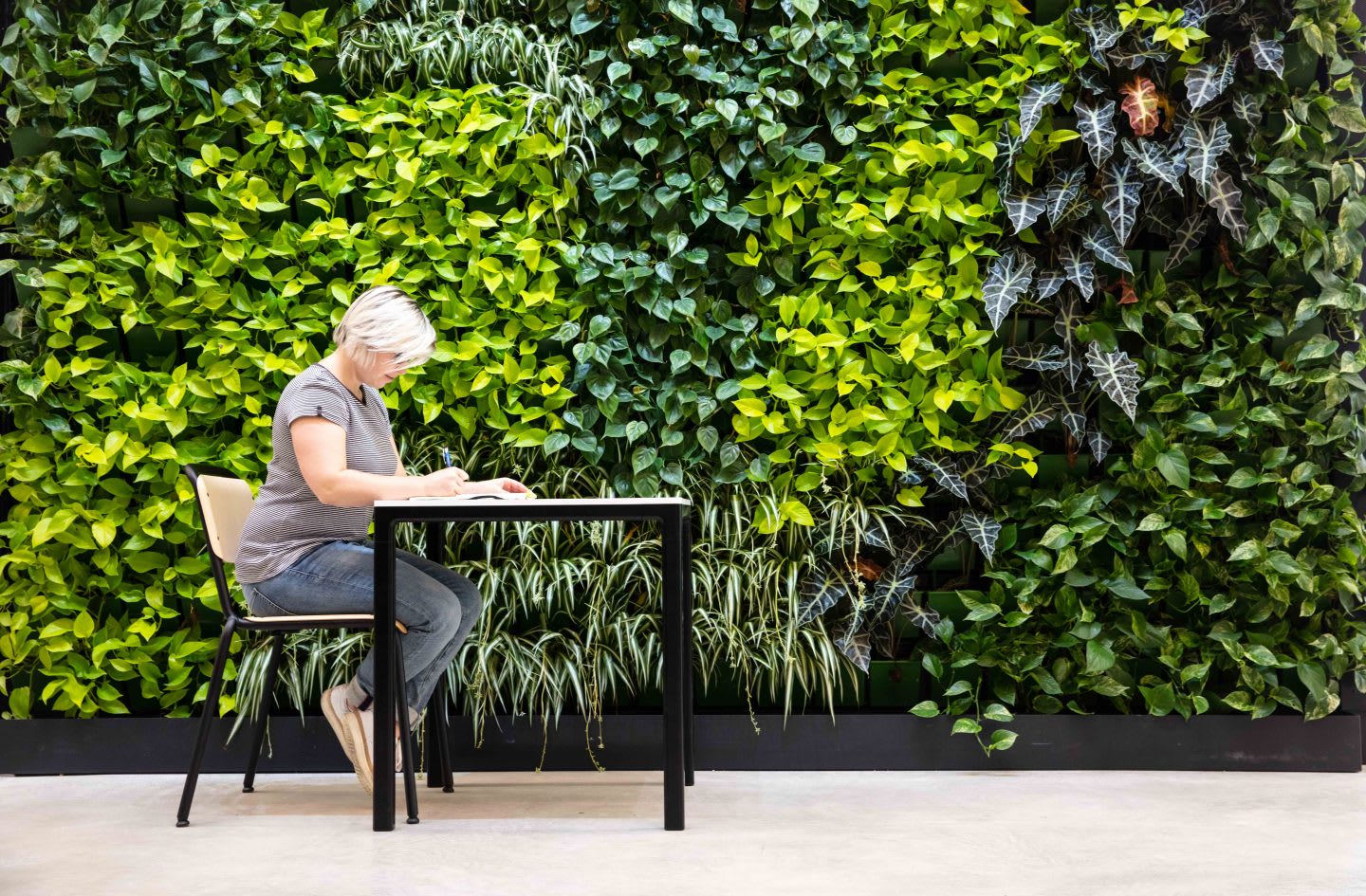 Woman focused and writing diary at work desk, work environment, healthy work place, healthy atmosphere, habits, routine, logging, consistency, adidas HQ, Herzogenaurach, GamePlan A