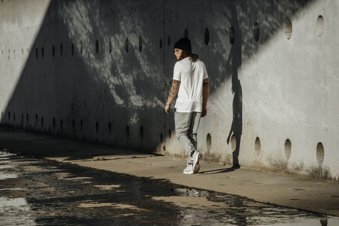 Guy walking on concrete in casual clothes after workout, urban environment, urban athlete, style, fashion, Reebok, GamePlan A