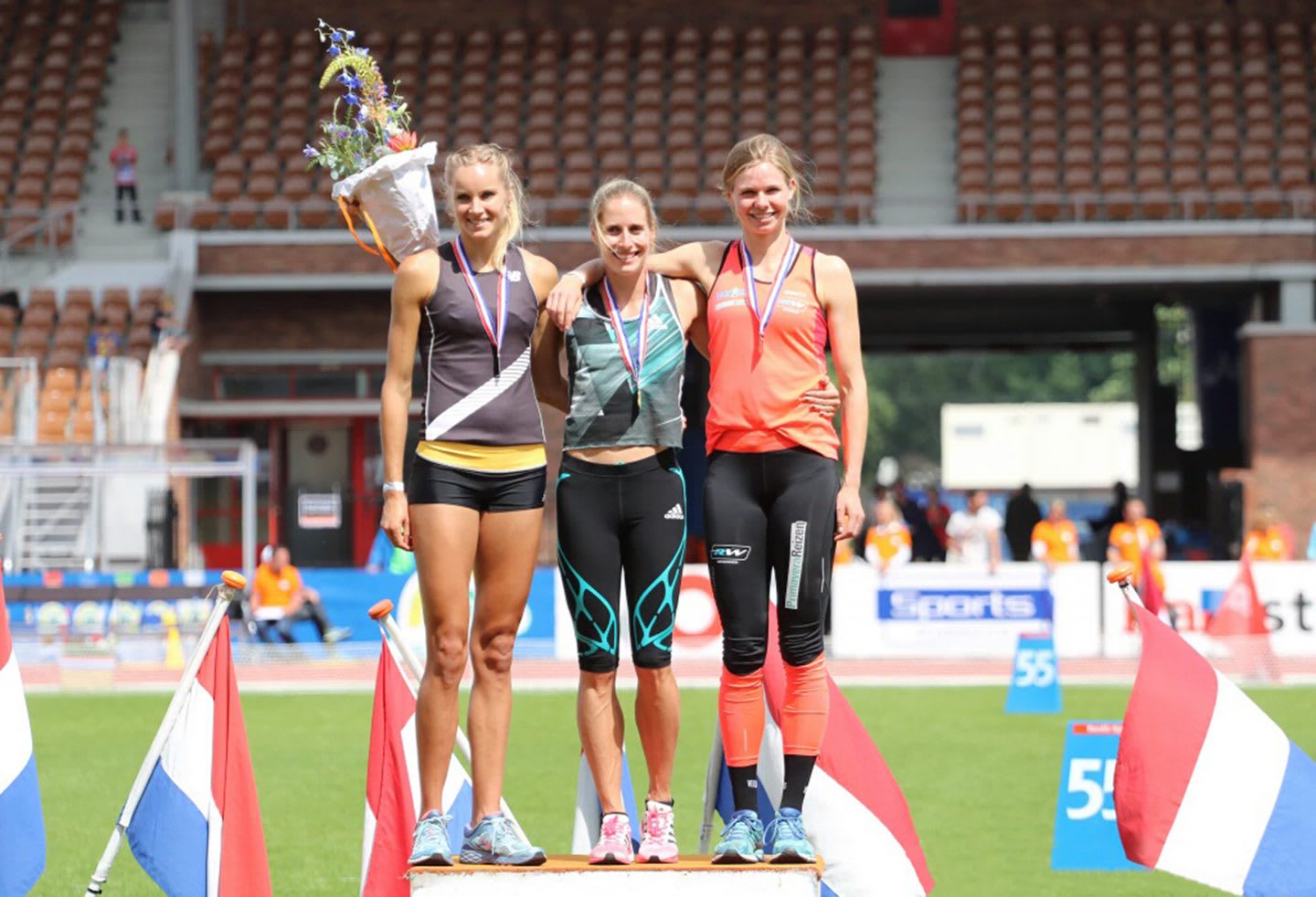 Three young athletes standing together on the winners' rostrum during an award ceremony. winning, setbacks, goal setting, achieving success, GamePlan A