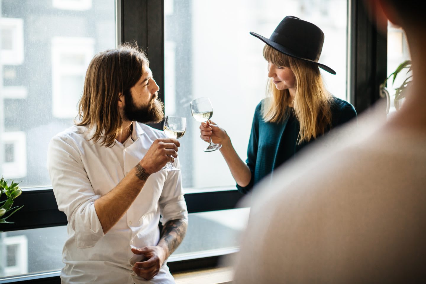 Two friends standing close toasting with glasses of wine. Balance, enjoying life, healthy lifestyle, trade-offs, GamePlan A.