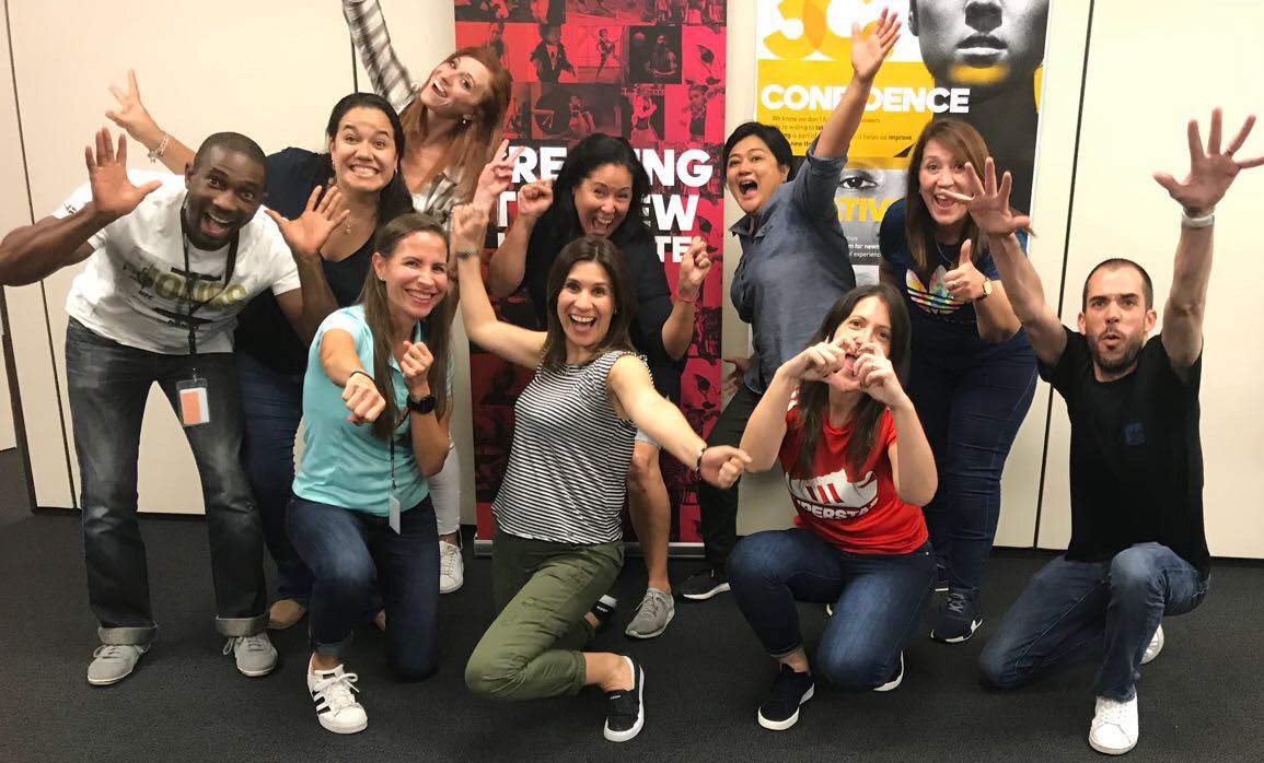 An adidas team photo showing excited employees posing in a funny way. Leadership, team, confidence, support, GamePlan A