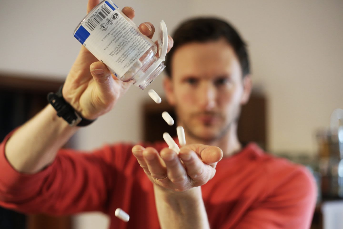 A guy putting a bunch of magnesium supplement pills into his hand. nutrition, health, supplements, magnesium, calm down, improve sleep, GamePlan A