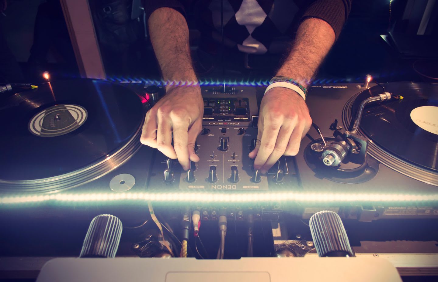 A person producing electronic music at a turntable. mixing music, mood, flow state, GamePlan A