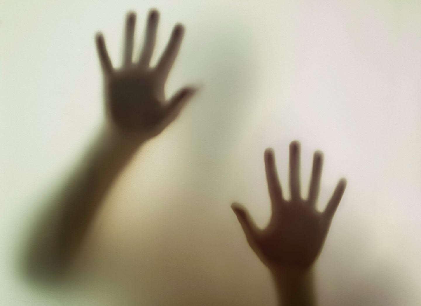 Hands viewed from a smoky glass