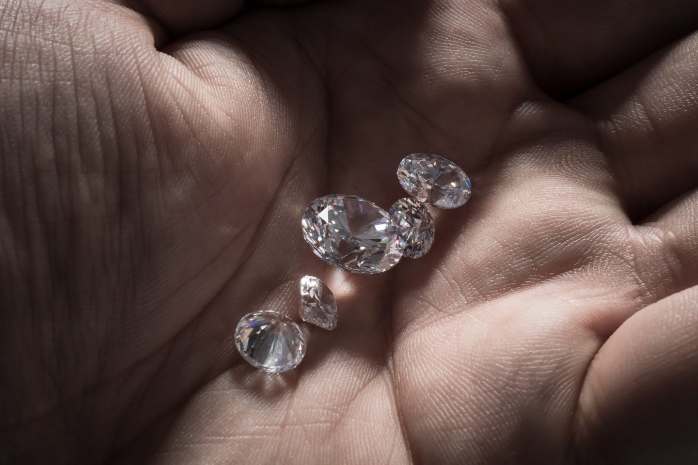 A close up of shiny diamonds in the palm of a hand. Sustainable Fashion, Gameplan A.