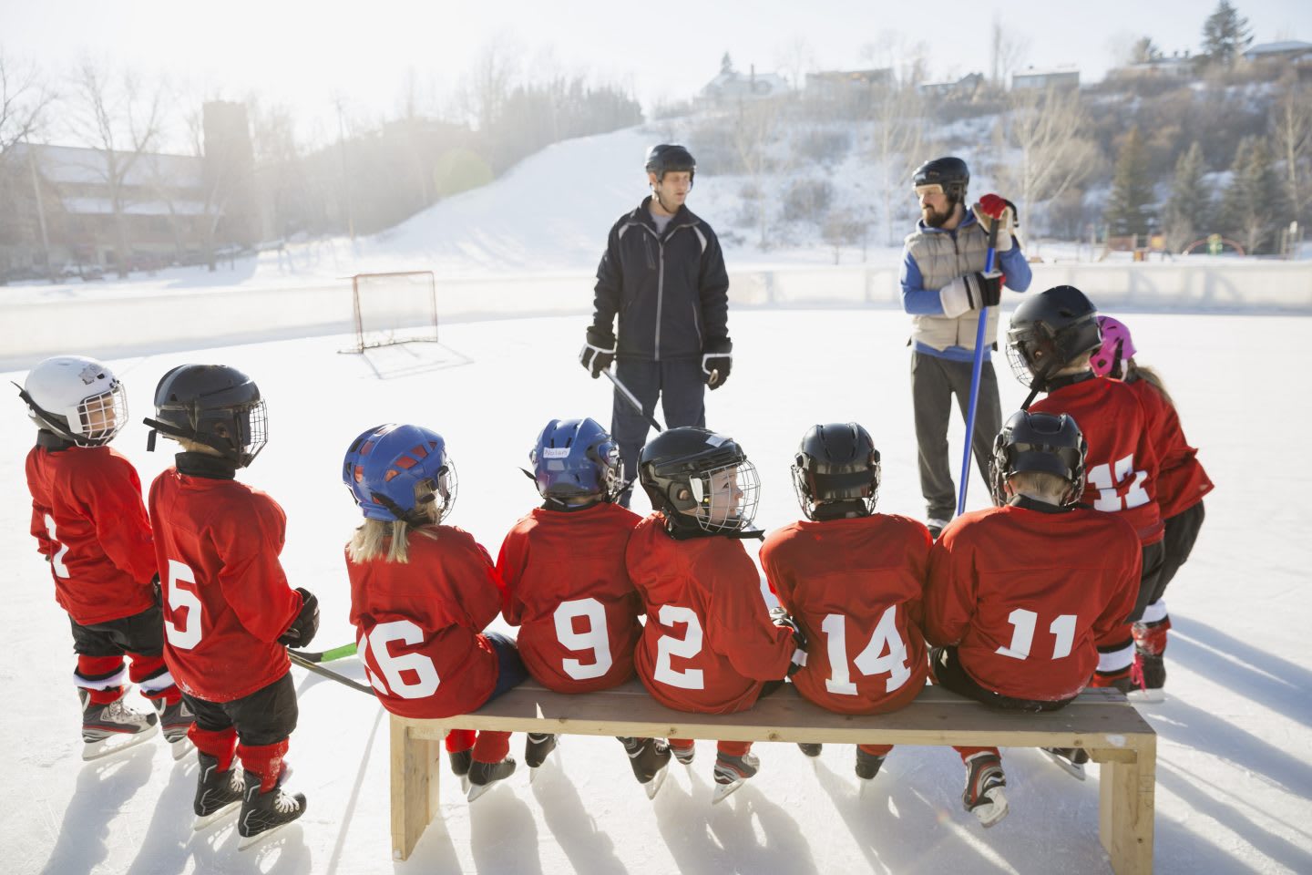 Coaches and ice hockey team on rink | Coaching