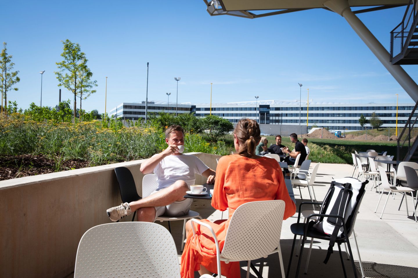 Two adidas employeeshaving having a coffee break on the terrace of the adidas Halftime building at the World of Sports in Herzogenaurach