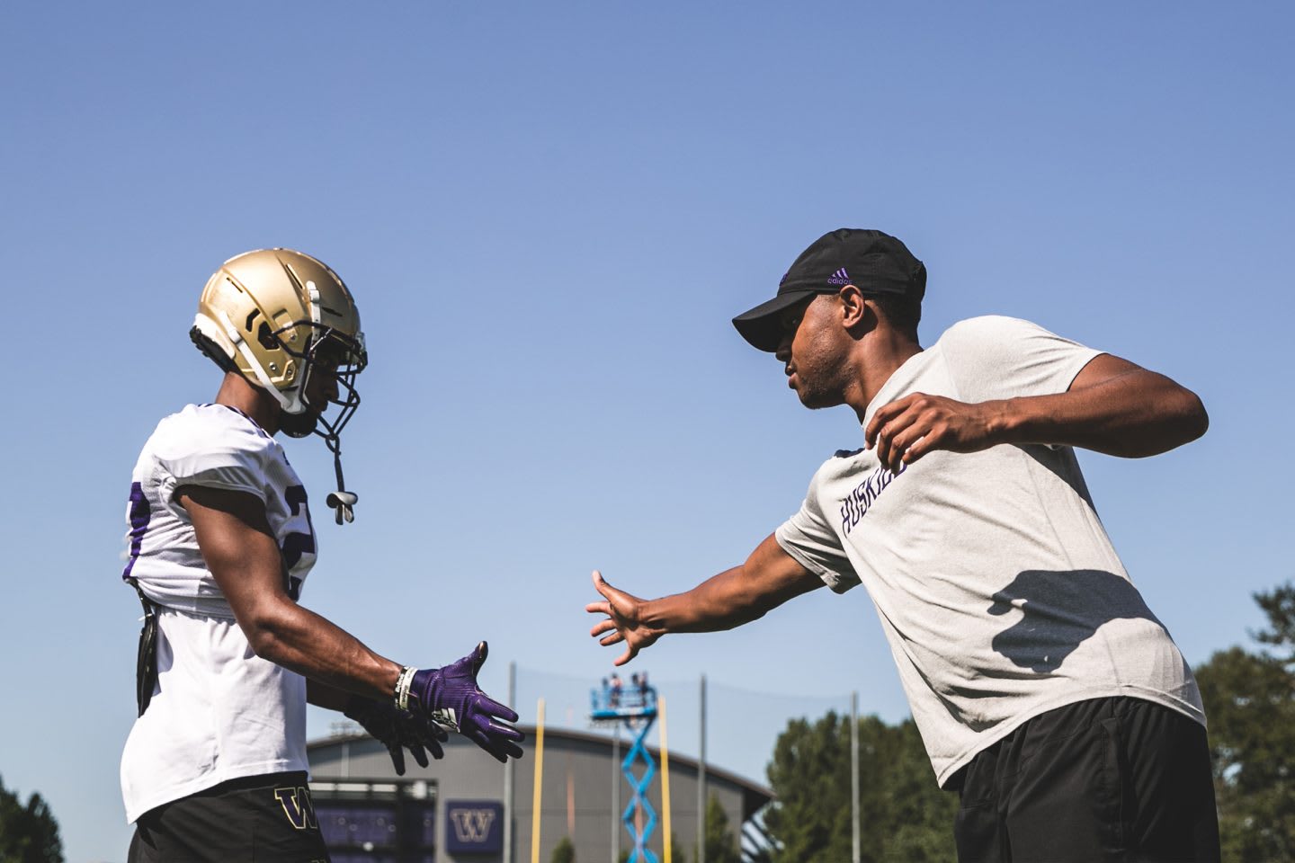coach and american football player shaking hands